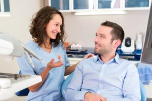 Dentist talking to patient.